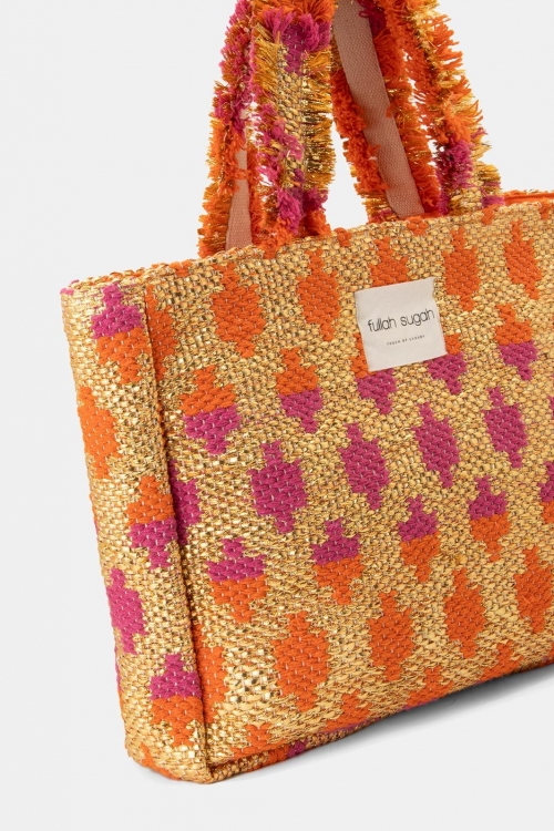 Woven bag with fringes and a bold pattern